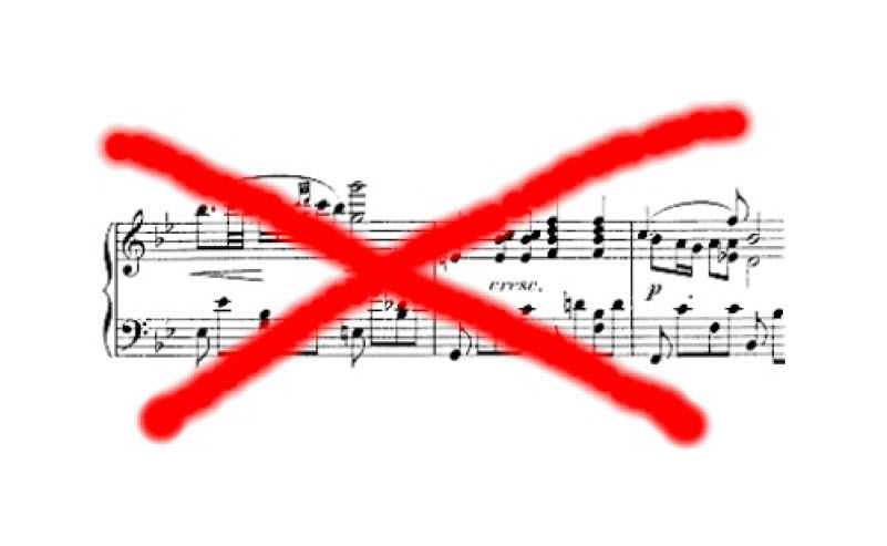 Music notation crossed out - fluency in music does not require reading music.